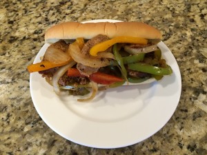 sausage with bell peppers and onions, confit